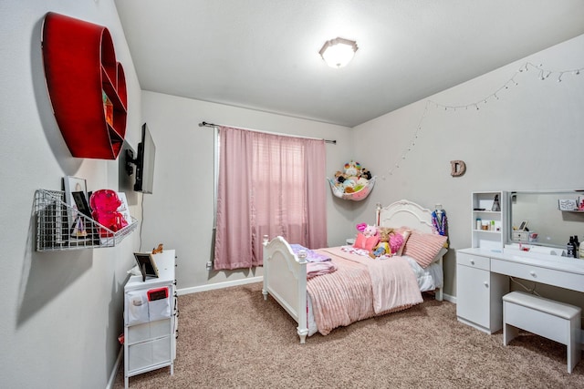 carpeted bedroom featuring baseboards