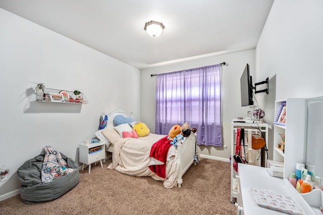 carpeted bedroom featuring baseboards