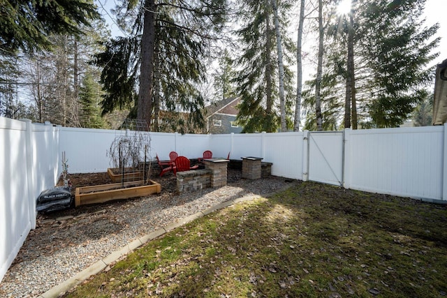 view of yard with a gate and a fenced backyard