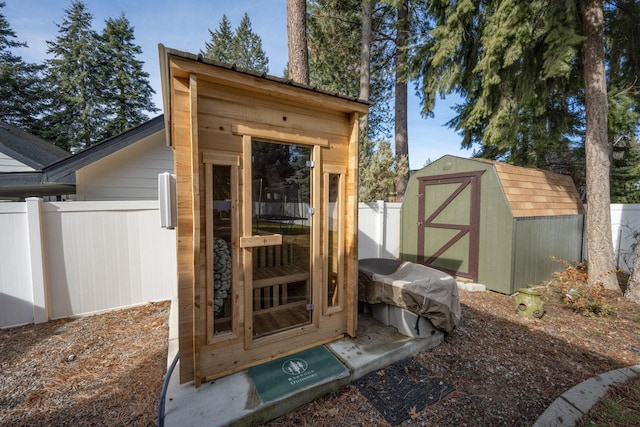 view of shed featuring fence