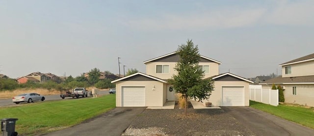 view of front of property with a garage, driveway, and a front yard