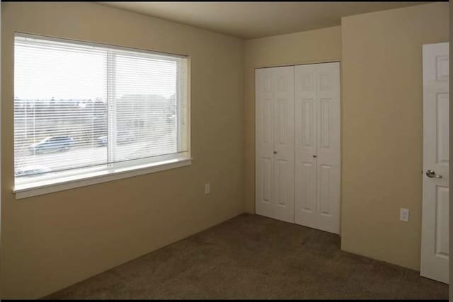 unfurnished bedroom featuring a closet and carpet