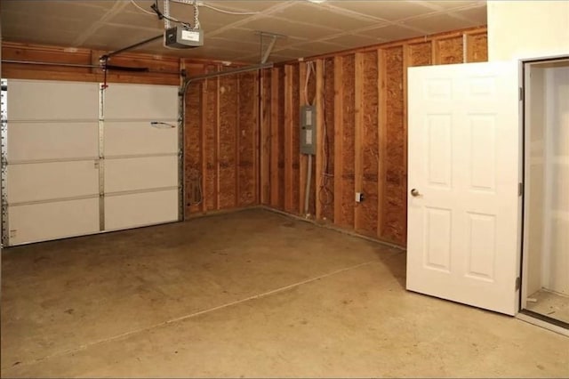 garage with electric panel and a garage door opener