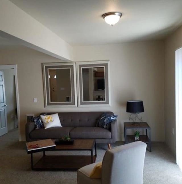 living area featuring light colored carpet