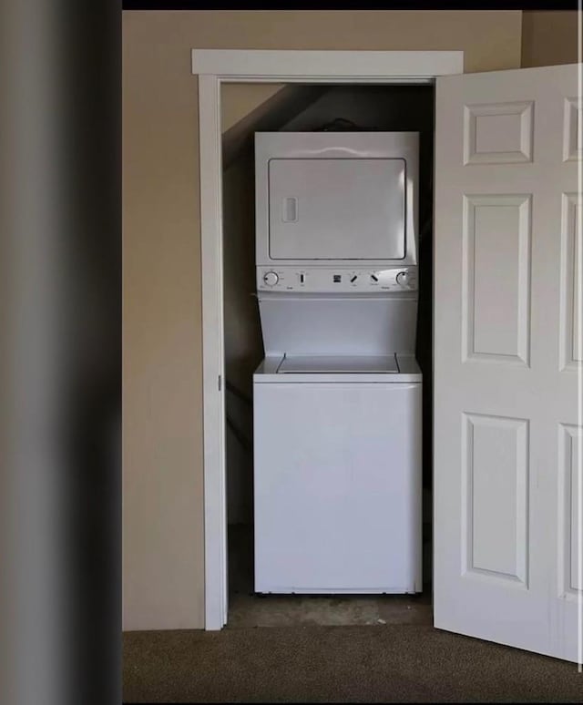 laundry room featuring stacked washer and dryer and laundry area