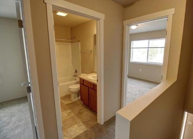 hallway featuring light colored carpet