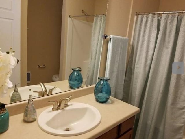 full bathroom with vanity, a shower with shower curtain, and toilet