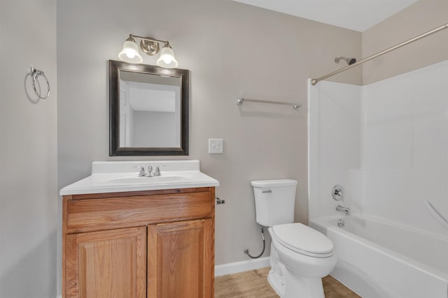 bathroom featuring toilet, vanity, baseboards, and washtub / shower combination