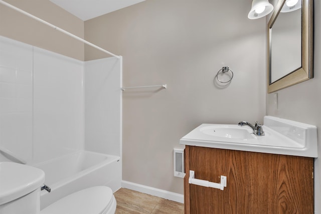 bathroom with vanity, baseboards, visible vents,  shower combination, and toilet