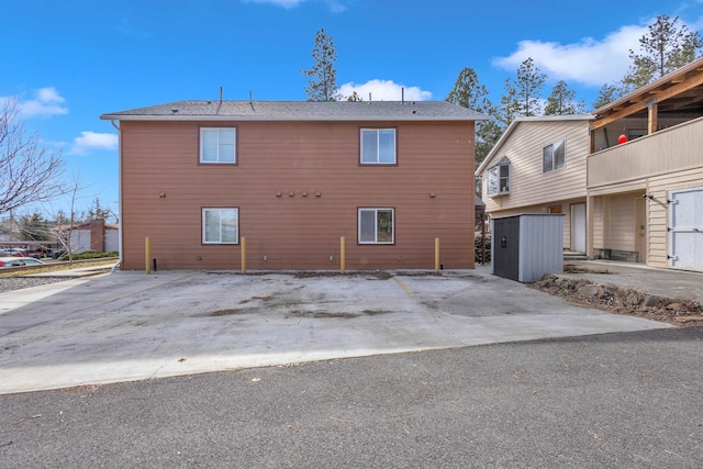 rear view of property featuring an outbuilding