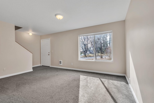 carpeted empty room with baseboards