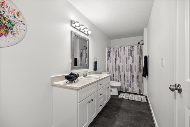 bathroom featuring vanity, a shower with shower curtain, toilet, and baseboards