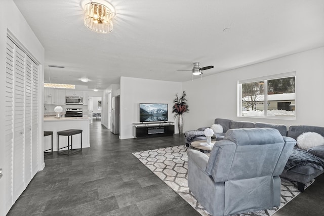 living area with a ceiling fan and visible vents