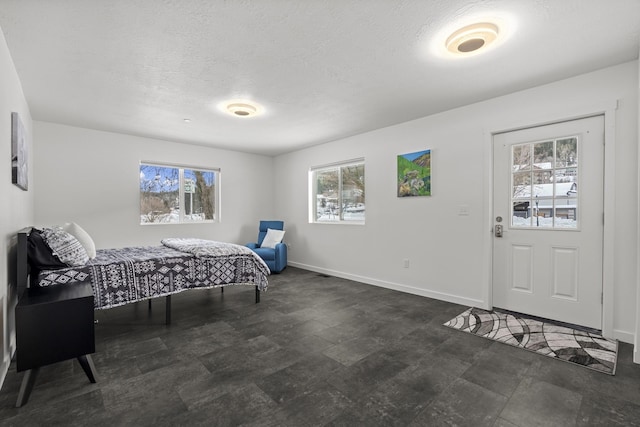 bedroom featuring a textured ceiling and baseboards