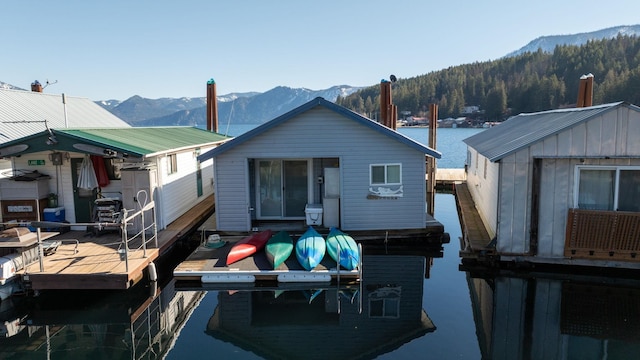 rear view of house with a water and mountain view