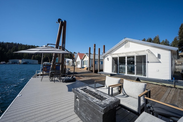 deck featuring outdoor dining space and an outdoor fire pit