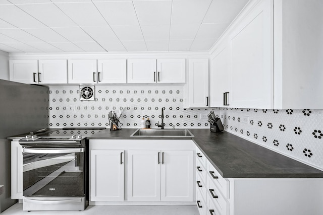 kitchen with a sink, visible vents, dark countertops, and electric stove