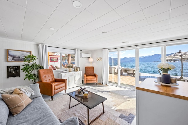 living area featuring a mountain view and an AC wall unit