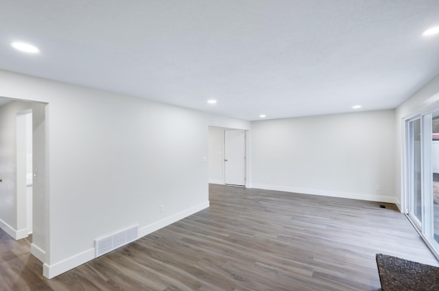 spare room featuring recessed lighting, visible vents, baseboards, and wood finished floors