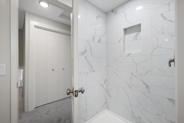 bathroom with tiled shower