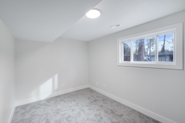 unfurnished room featuring visible vents, baseboards, and carpet floors