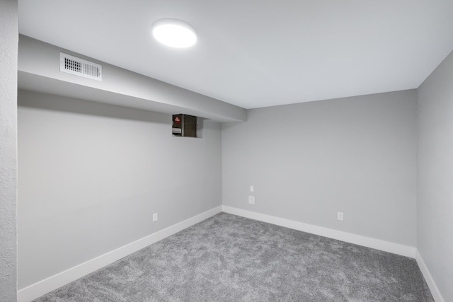 finished basement featuring visible vents, baseboards, and carpet