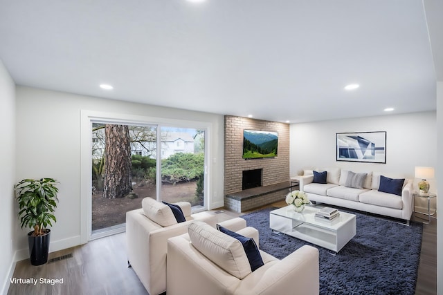 living area featuring visible vents, recessed lighting, and wood finished floors