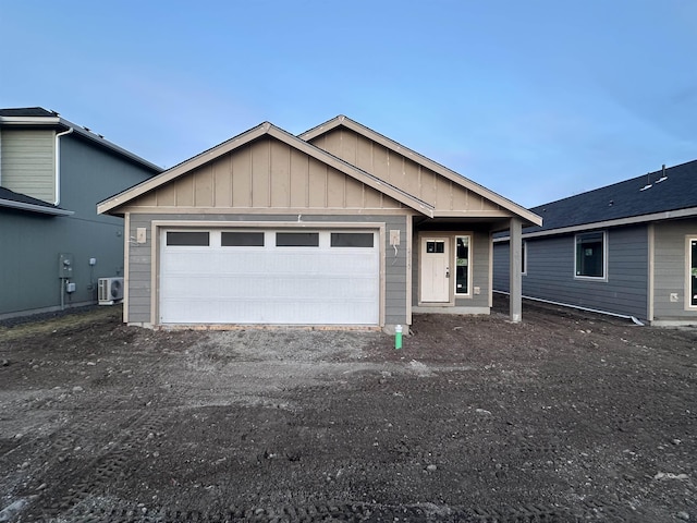 single story home with a garage, board and batten siding, and driveway