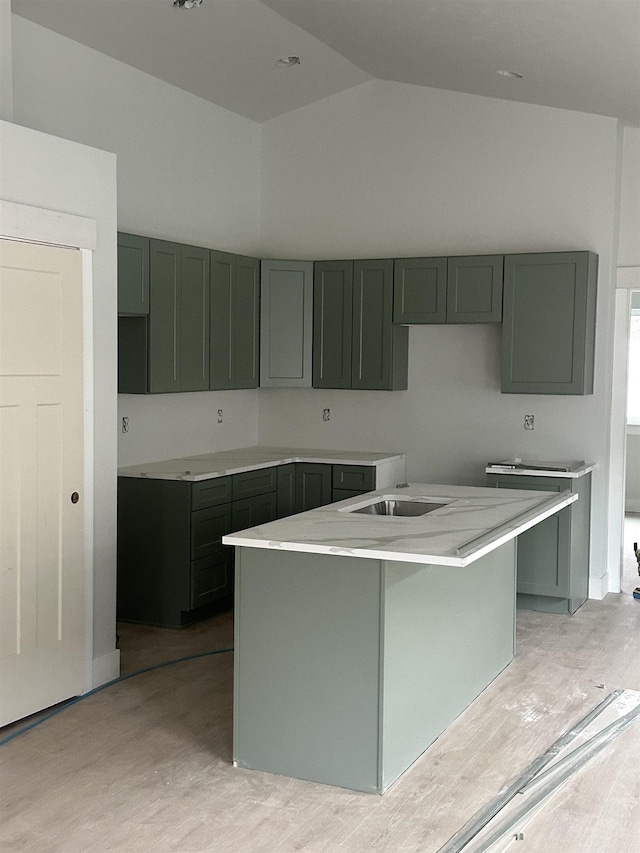 kitchen featuring high vaulted ceiling and a kitchen island