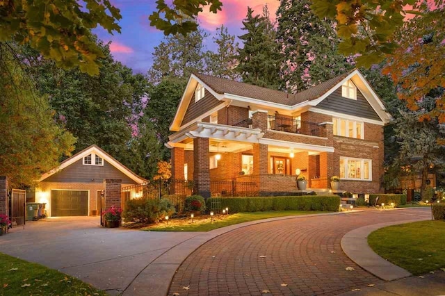 view of front of home featuring brick siding, a porch, a garage, a balcony, and driveway