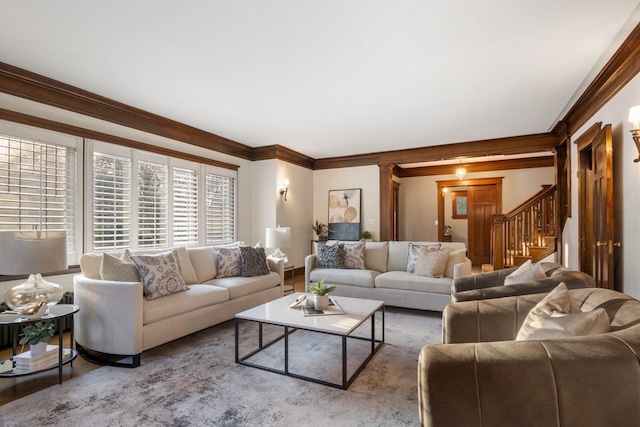 living area featuring stairway, wood finished floors, baseboards, and ornamental molding