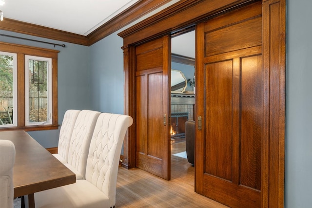 home office featuring crown molding and wood finished floors