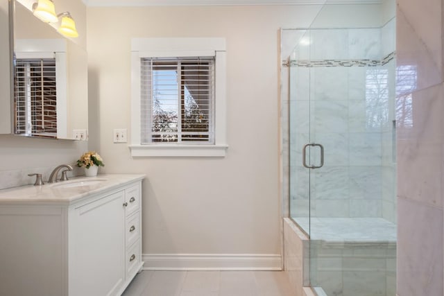 bathroom with vanity, a shower stall, and baseboards