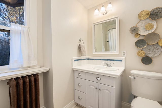 bathroom with toilet, backsplash, radiator, baseboards, and vanity