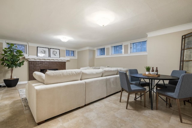 living area with a fireplace, baseboards, and ornamental molding