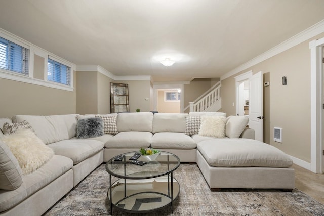 living room with visible vents, stairway, baseboards, and ornamental molding