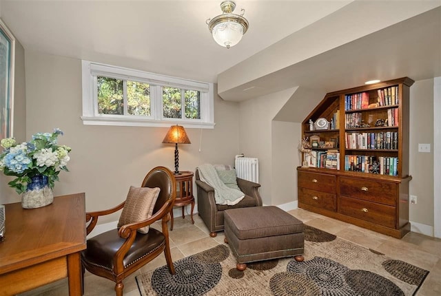 living area with radiator heating unit and baseboards