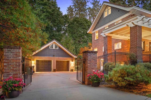 view of home's exterior featuring a gate, fence, an outdoor structure, a detached garage, and brick siding