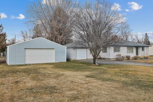 detached garage featuring driveway