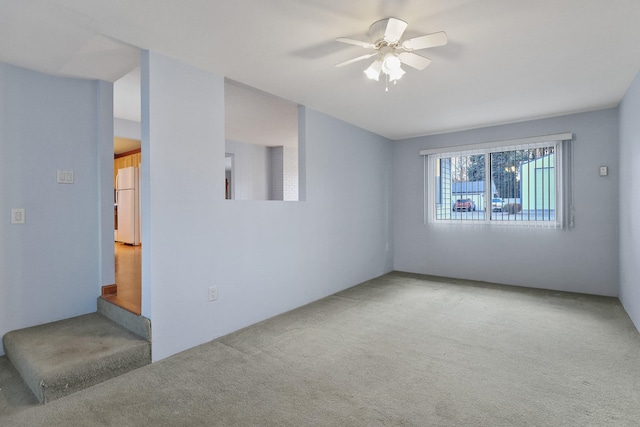 spare room with carpet floors and ceiling fan