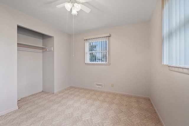 unfurnished bedroom with visible vents, baseboards, carpet, a closet, and a ceiling fan