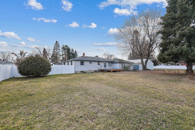 rear view of property featuring a fenced backyard, a yard, and a deck