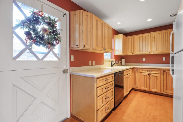 kitchen with a sink, freestanding refrigerator, recessed lighting, light countertops, and dishwasher