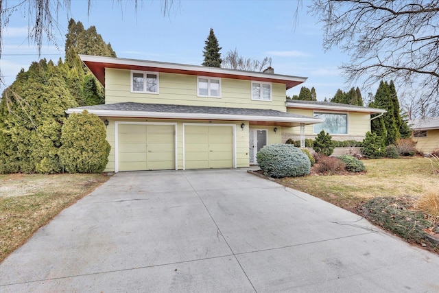 traditional home with driveway, a shingled roof, a garage, and a front yard