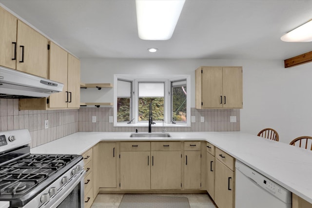 kitchen with tasteful backsplash, stainless steel range with gas cooktop, under cabinet range hood, light brown cabinetry, and dishwasher