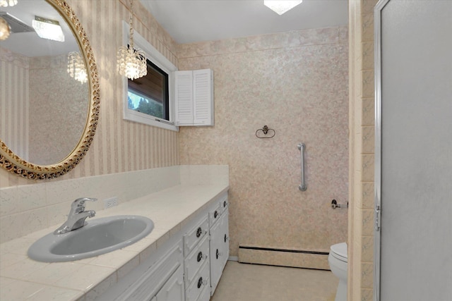 full bath with a baseboard heating unit, toilet, vanity, and wallpapered walls