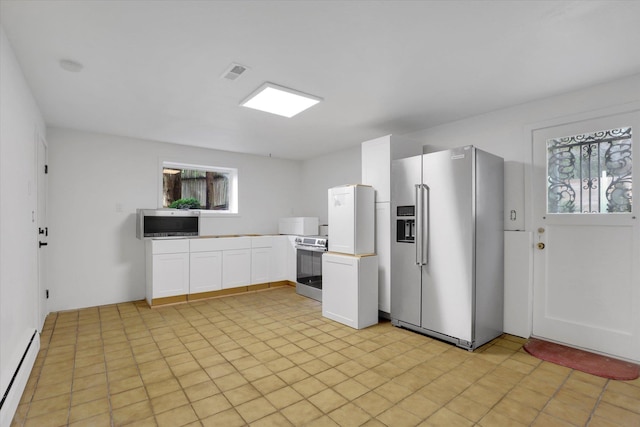 kitchen featuring white cabinetry, baseboard heating, and stainless steel appliances