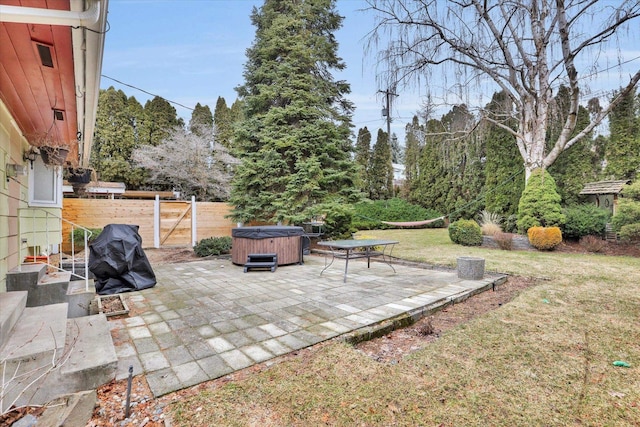 view of yard with a patio, a hot tub, and fence