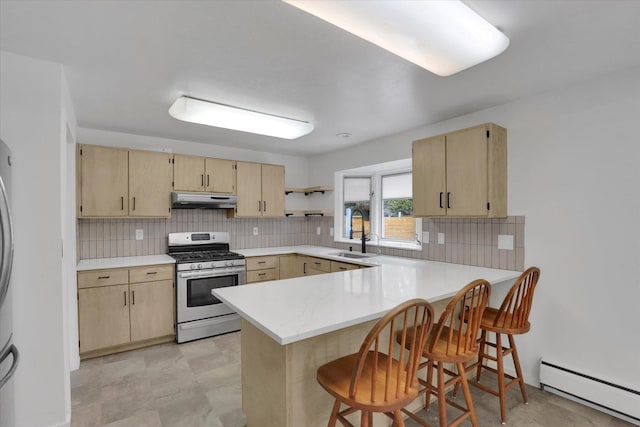 kitchen featuring under cabinet range hood, baseboard heating, light brown cabinets, and stainless steel range with gas cooktop