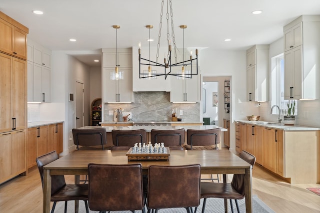 dining room featuring light wood finished floors and recessed lighting